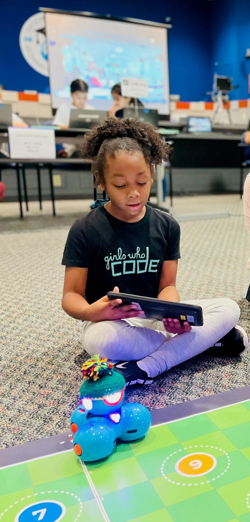 Girl coding with robot